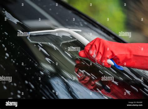 hand using squeegee to washing windshield of a car Stock Photo - Alamy