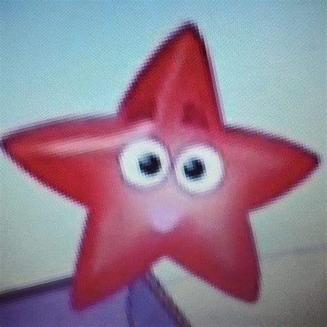 a red star with googly eyes on it's face is in front of a white wall