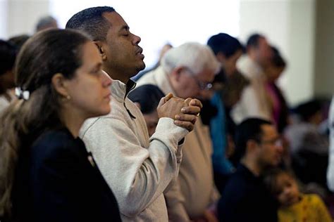 The congregation pray during a Sunday service at Congregacion Leon de ...