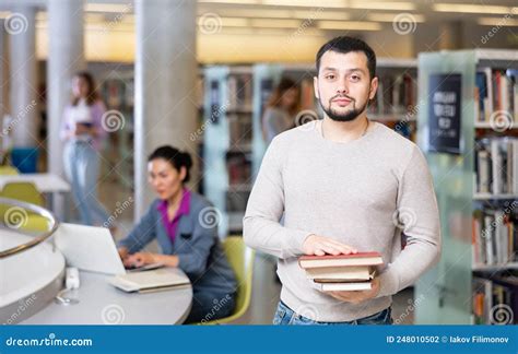 Portrait of a Student Guy in the Library with Textbooks Stock Photo ...