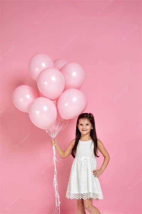 Premium Photo | Happy cute little child girl posing with pastel pink ...