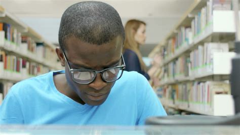 Young man studying in library at school 1397652 Stock Video at Vecteezy