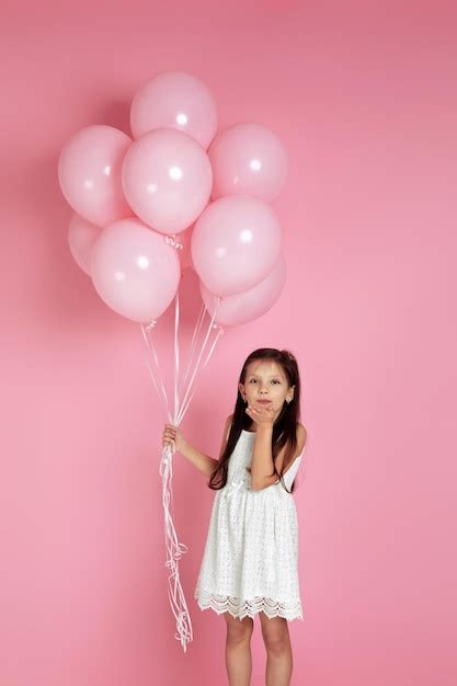 Premium Photo | Smiling adorable little child girl with pastel pink air ...