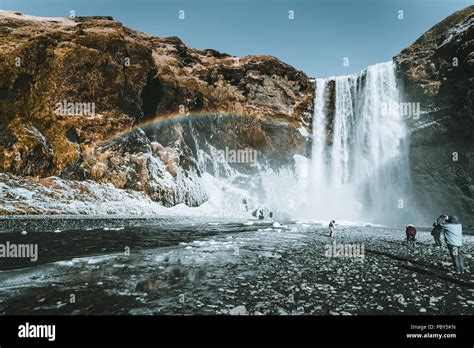 Skogafoss waterfall in Iceland with rainbow on a sunny day with blue ...