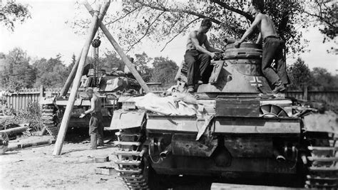 Crew of a Wehrmacht repair unit working on a Panzer III | World War Photos