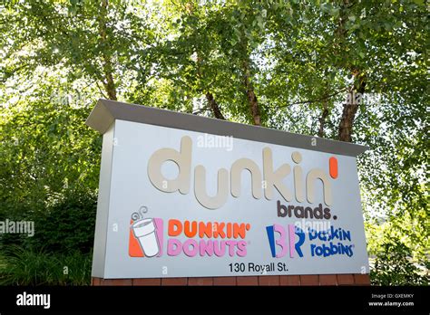 A logo sign outside of the headquarters of Dunkin' Brands Group, Inc ...