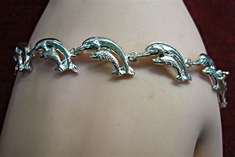 STERLING SILVER DOLPHIN BRACELET WITH 11 LINKED DOLPHINS W/CALF – NICE