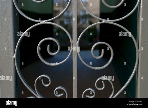 Iron gate with building in background Stock Photo - Alamy