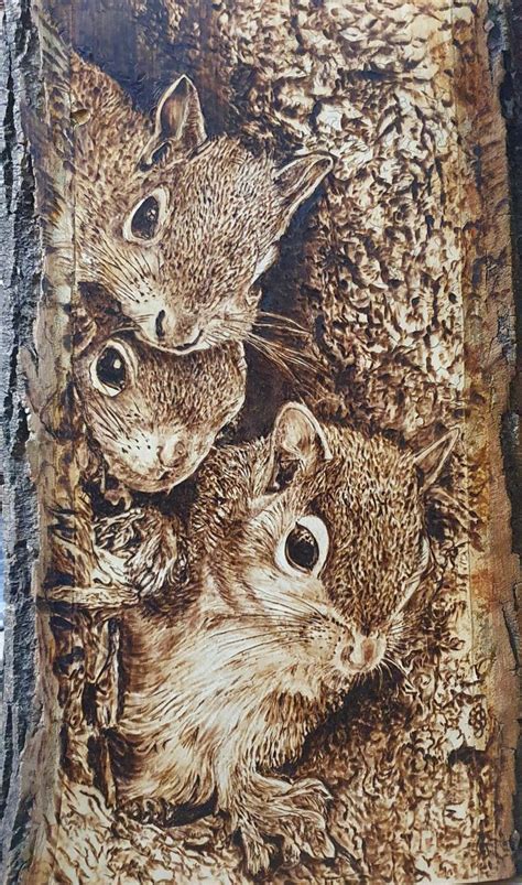 an image of three small animals on a piece of wood that is carved into ...