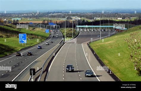 THE M6 TOLL ROAD MOTORWAY WITH LIGHT TRAFFIC AND TOLL BOOTHS AT WEEFORD ...