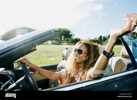 Mixed race woman driving convertible Stock Photo - Alamy