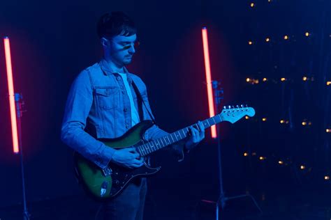 Man Singing while Playing an Electric Guitar · Free Stock Photo