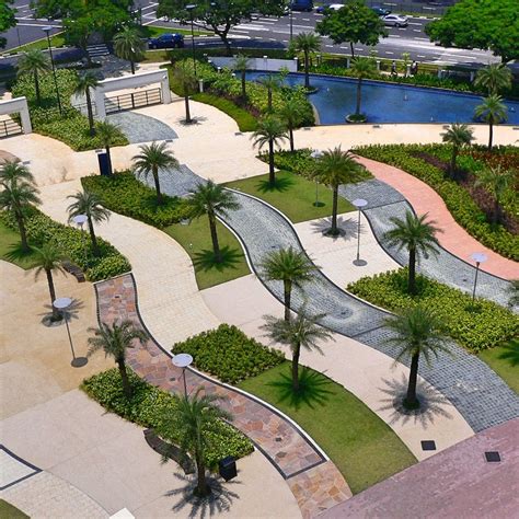 an aerial view of a park with palm trees, benches and walkways in the ...