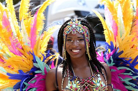 Notting Hill Carnival revellers strut their stuff in sequinned ...