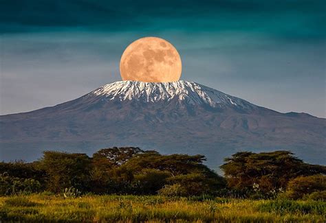 The full moon rises over Mount Kilimanjaro, Tanzania, Africa. February ...