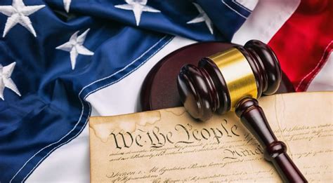 Stock photo of the U.S. Constitution with a gavel and the American flag ...