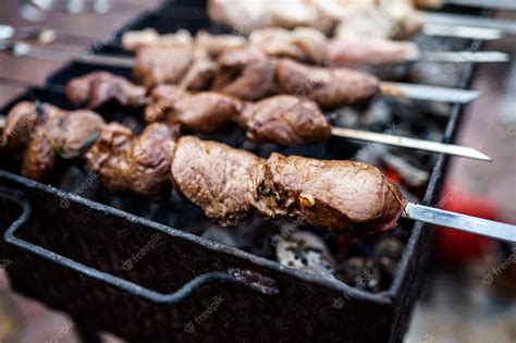 Premium Photo | Shish kebab of elite veal skewered on a grill close-up ...