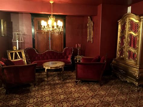 Parlor room Maroon velvet sofa paired with English club chairs Gold ...