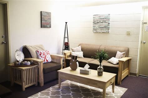 a living room with two couches and a coffee table in front of the door