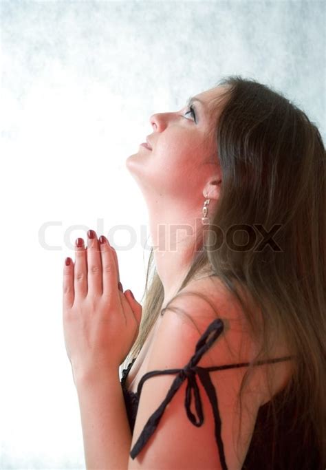 Young woman praying to god | Stock Photo | Colourbox