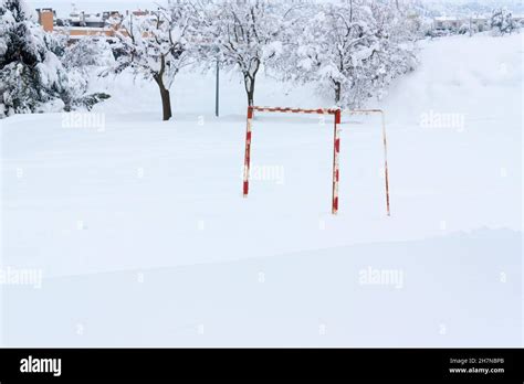 snowy football field of which only the goal can be seen, beginning of ...