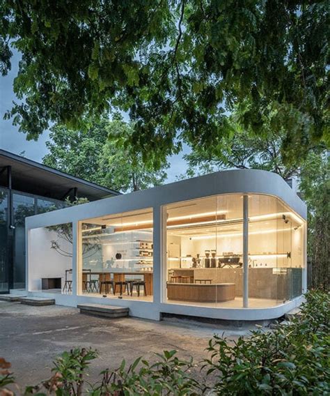 spacy architecture wraps serene bangkok cafe in floating glass