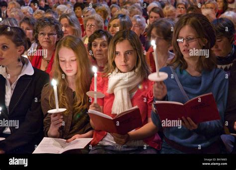 Congregation singing and holding candles during filming of BBC Songs of ...