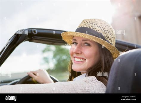 Caucasian woman driving convertible Stock Photo - Alamy