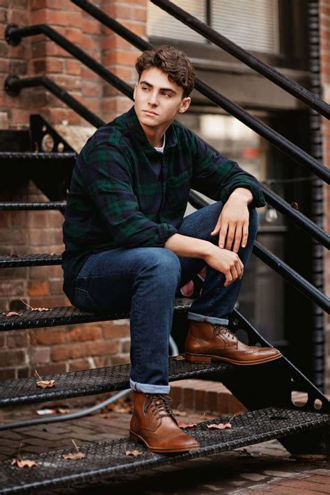 Download A Young Man Sitting On Stairs In A Plaid Shirt | Wallpapers.com