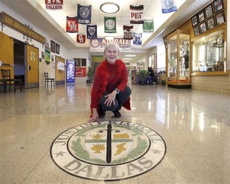 a woman kneeling down on the floor in a building