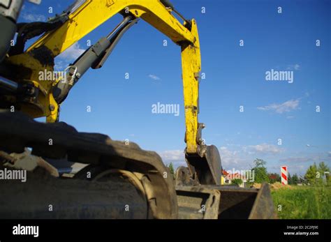 Excavator at a construction site. Digger machine Stock Photo - Alamy