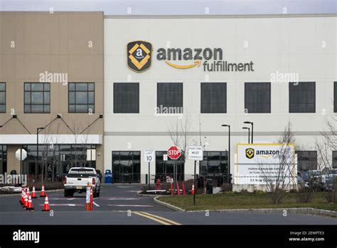 A logo sign outside of an Amazon Fulfillment center in Robbinsville ...