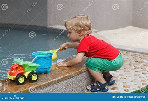 Baby playing with water stock image. Image of pour, happiness - 25584015