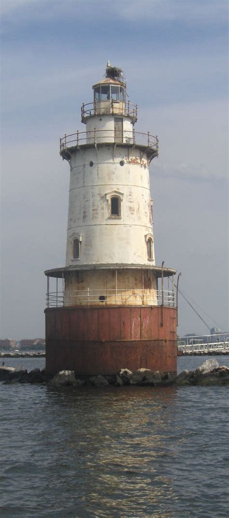 a light house sitting on top of a body of water