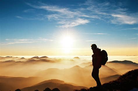 Hiker On Mountain At Sunset by Alexsava