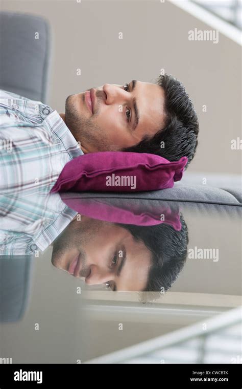 Man resting on a couch Stock Photo - Alamy