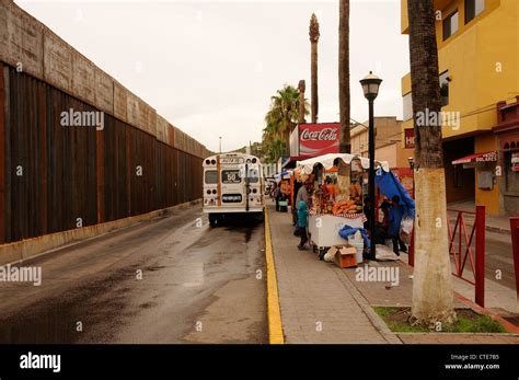 Locals walk near the border wall in Nogales, Sonora, Mexico, located ...