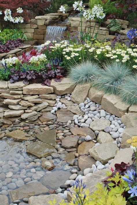 A fantastic use of rockery stone and cobbles to create this beautiful ...