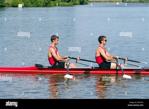 Two man racing shell boat with crew rowing Stock Photo - Alamy