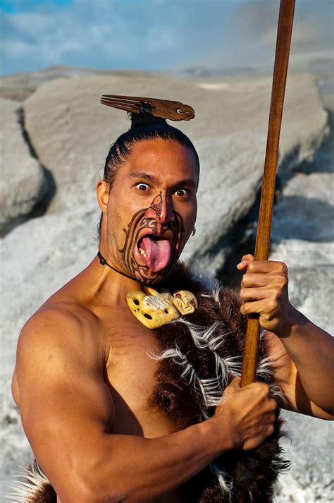 A Maori warrior with a ta moko (facial tattoo) performs a war haka ...