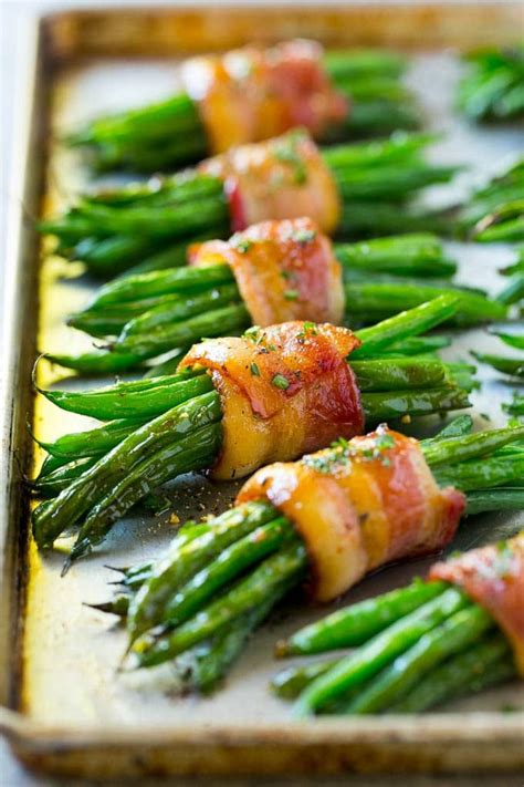 A row of green bean bundles on a pan. | Thanksgiving recipes side ...