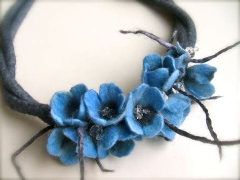 a close up of a blue flower on a black headband