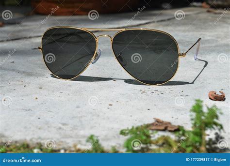 Gold Frame Aviator Black Sunglasses on Floor Stock Image - Image of ...