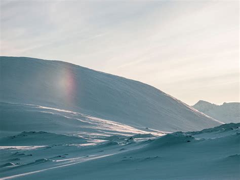 Snow Covered Hill Under White Clouds · Free Stock Photo