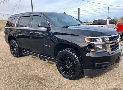 a black suv parked in a parking lot