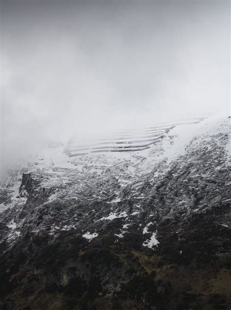 A snowy mountain with a snow covered slope · Free Stock Photo