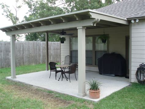 a covered patio with table and chairs on it