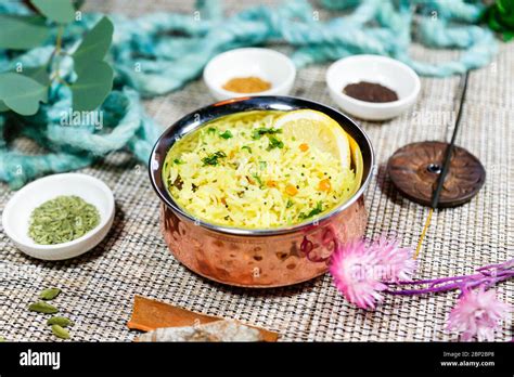 Indian traditional pilaf with lemon, herbs and spices in a shiny bowl ...