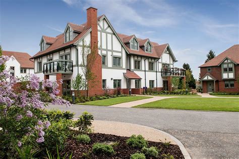 a large white and red brick house with lots of windows on the second ...