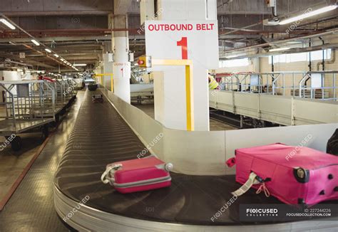 Luggage on the baggage carousel at airport terminal — red, anticipation ...